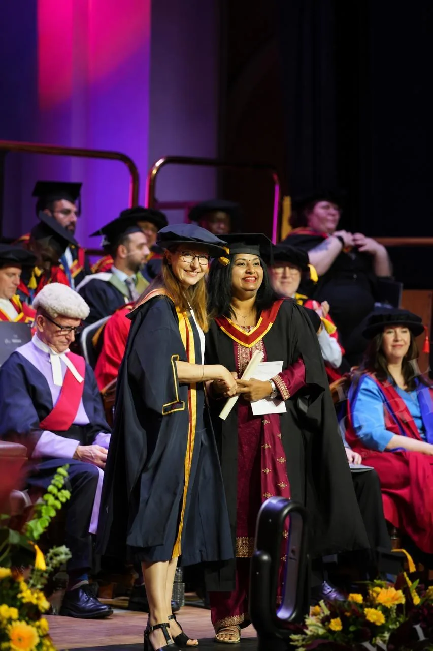 Dr. Sumitra M Patil receiving her doctorate on stage at her PhD convocation