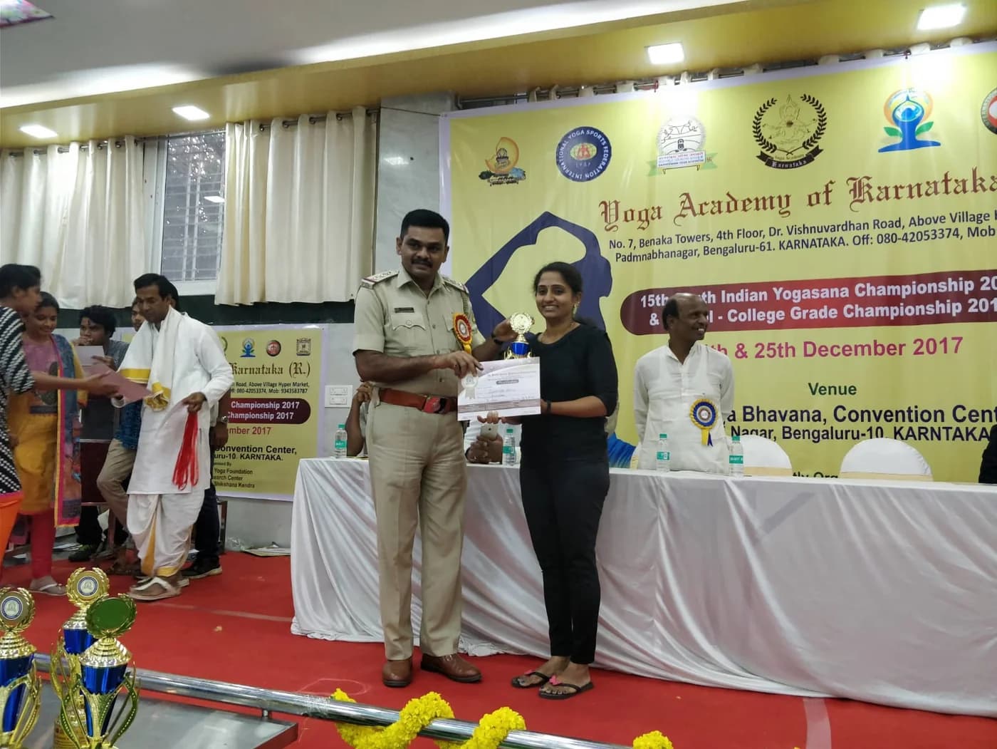 An award presentation at the 15th South Indian Yogasana Championship, December 2017